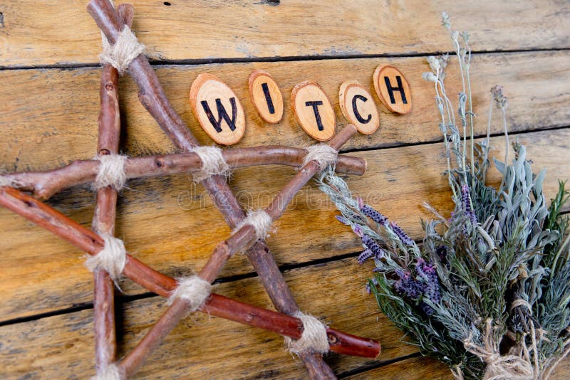 Natural Witch - rustic branch pentagram and dried herbs with the word Witch burnt letters on wooden background