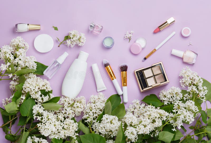 Natural woman make up cosmetics with spring white lilac bloom. Top view