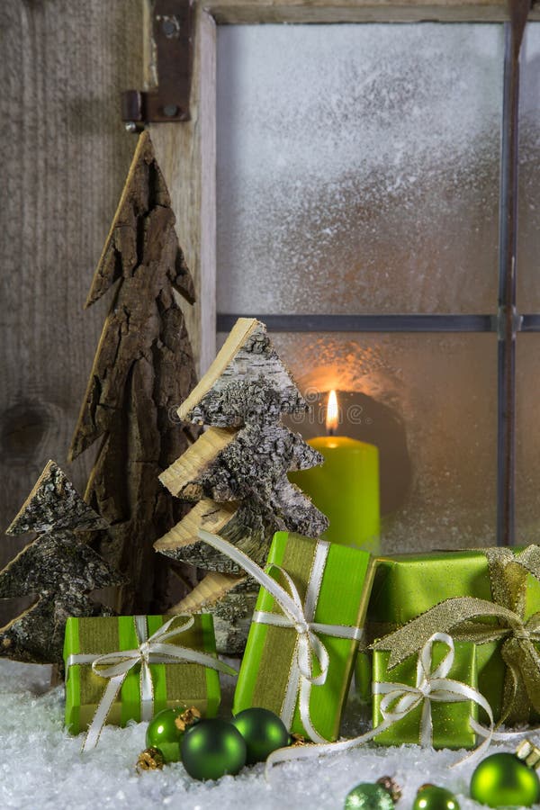 Natural wooden christmas decoration with candles and green gift boxes. Natural wooden christmas decoration with candles and green gift boxes.