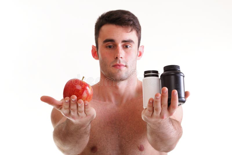 Natural apple vitamin or pill drag tablet Man isolated offering apple in one and pills in bottle - in another hand. Copy space boxes with supplements. Natural apple vitamin or pill drag tablet Man isolated offering apple in one and pills in bottle - in another hand. Copy space boxes with supplements