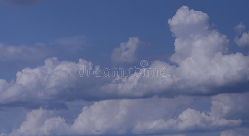 Nature background.Many white fluffy cumulus clouds against a blue sky. stock images Nature background.Many white fluffy cumulus clouds against a blue sky. stock images