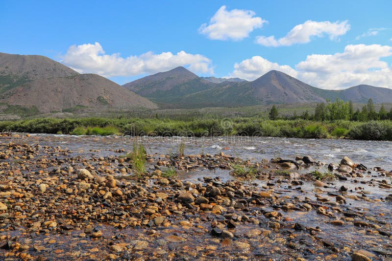 The nature of Kolyma: river and mountains on a sunny summer day, Magadan region, Russian Far East