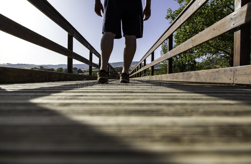 Man`s feet on wooden walkway royalty free stock photo