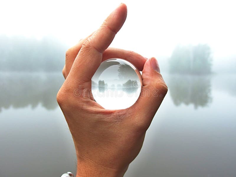 Nature by water in a magic glass ball, hold in my hand