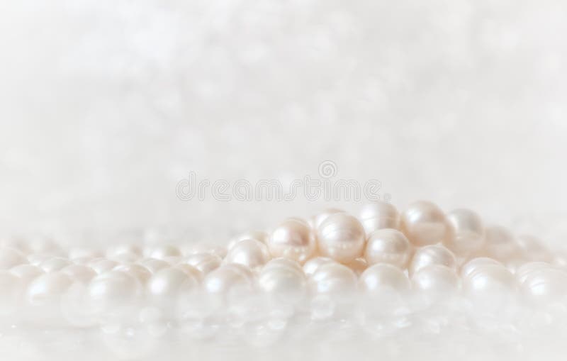 Nature white string of pearls on a sparkling background in soft focus, with highlights