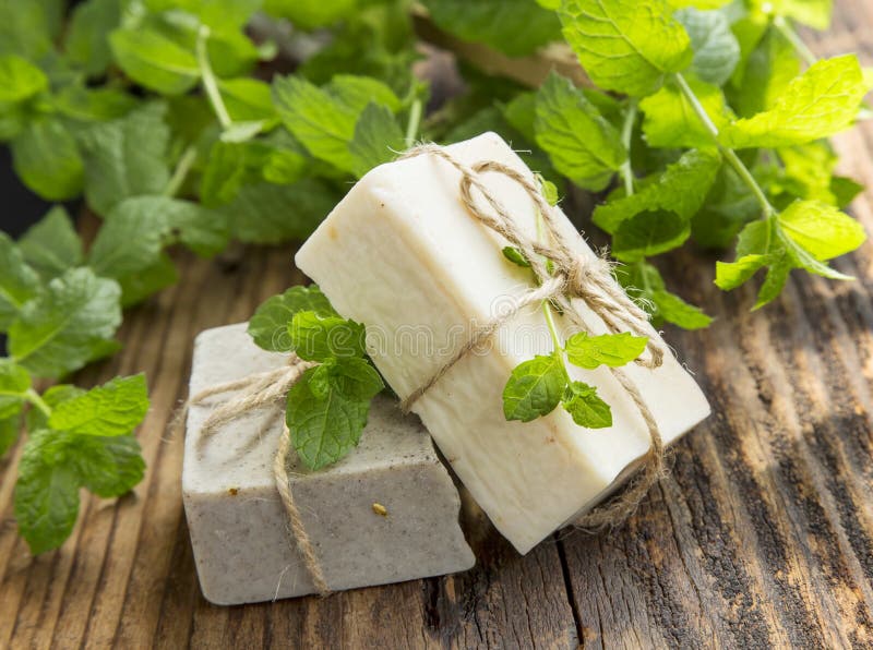 Natural organic mint soaps with mint leaves on wooden background. Natural organic mint soaps with mint leaves on wooden background