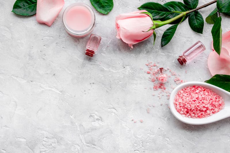Naturliga organiska skönhetsmedel med rosolja Kräm lotion, brunnsort som är salt på grå copyspace för bästa sikt för bakgrund royaltyfri bild Naturliga organiska skönhetsmedel med rosolja Kräm lotion, brunnsort som är salt på grå copyspace för bästa sikt för bakgrund royaltyfri bild