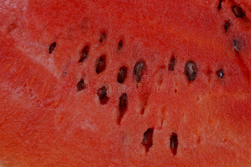 Natürliche rote Beschaffenheit eines Stückes der reifen frischen Wassermelone lizenzfreie stockfotografie Natürliche rote Beschaffenheit eines Stückes der reifen frischen Wassermelone lizenzfreie stockfotografie