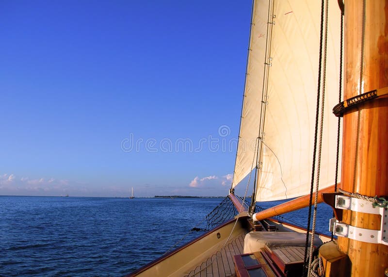 Sun, sea, islands, and wind fills the sails as seen from the deck of a wooden sailing vessel near Key West, Fla. Sun, sea, islands, and wind fills the sails as seen from the deck of a wooden sailing vessel near Key West, Fla.