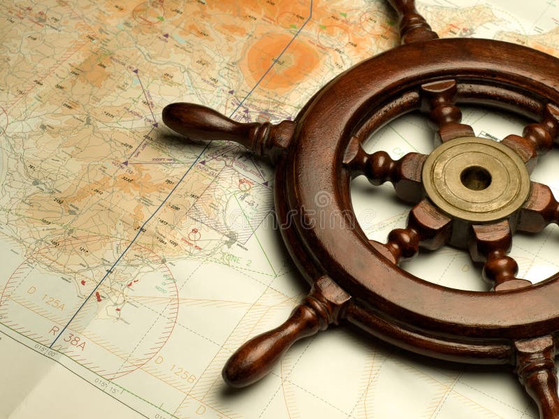 Helm and nautical map, useful for various navigation or travel themes. Helm and nautical map, useful for various navigation or travel themes