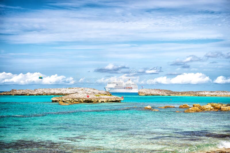 Navio de cruzeiros no mar no grande cay do estribo, Bahamas no dia ensolarado Forro de oceano na água de turquesa no céu azul Fér fotografia de stock Navio de cruzeiros no mar no grande cay do estribo, Bahamas no dia ensolarado Forro de oceano na água de turquesa no céu azul Fér fotografia de stock