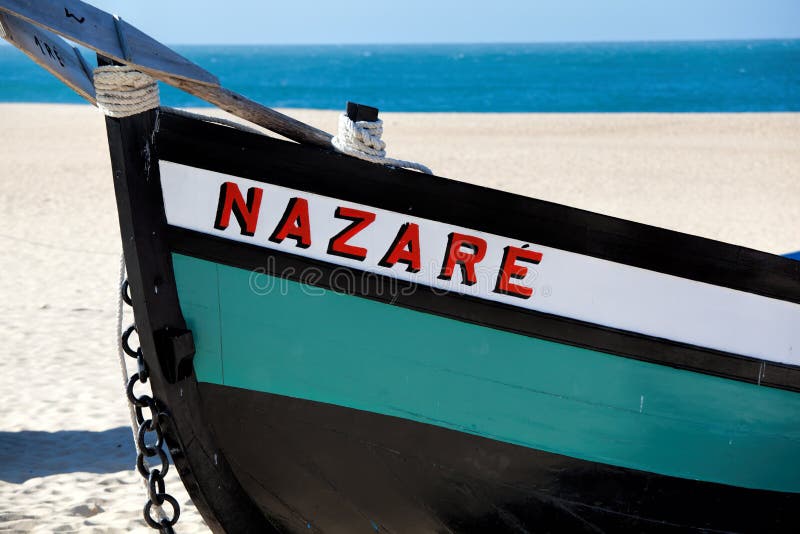Nazare, Portugal - November 5, 2017: colorful traditional old wooden fishing boat on the beach of fishing village of Nazare . royalty free stock photography Nazare, Portugal - November 5, 2017: colorful traditional old wooden fishing boat on the beach of fishing village of Nazare . royalty free stock photography