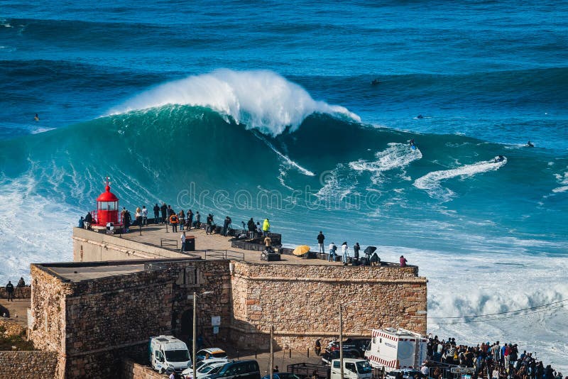 Nazare, Portugal, Surfer Riding Giant Wave in Front of Nazare Lighthouse