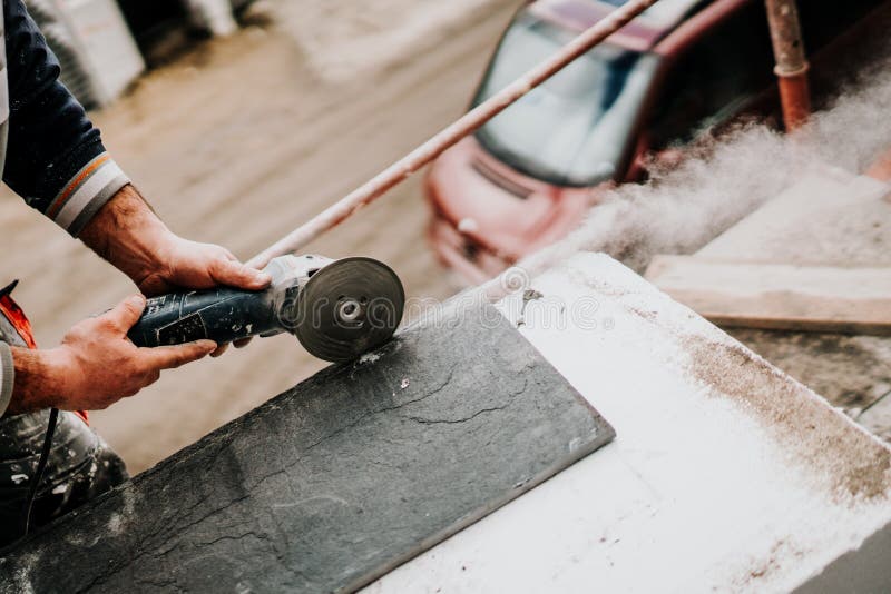 Close up details of industrial worker cutting stone marble with angle grinder at construction site. Bricklayer tiler stock images, royalty-free photos and pictures