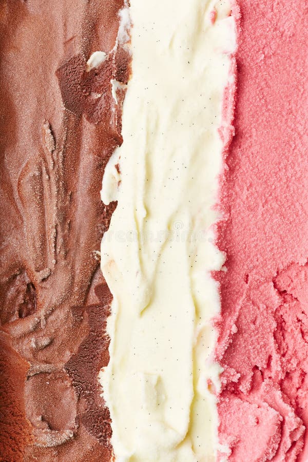 Stripes of neapolitan ice cream from above with chocolate, vanilla and strawberry ice cream. Stripes of neapolitan ice cream from above with chocolate, vanilla and strawberry ice cream