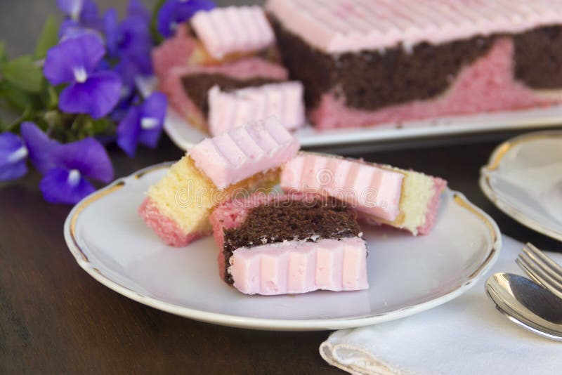 Delicious sliced neapolitan cake laid out for afternoon tea. Delicious sliced neapolitan cake laid out for afternoon tea.