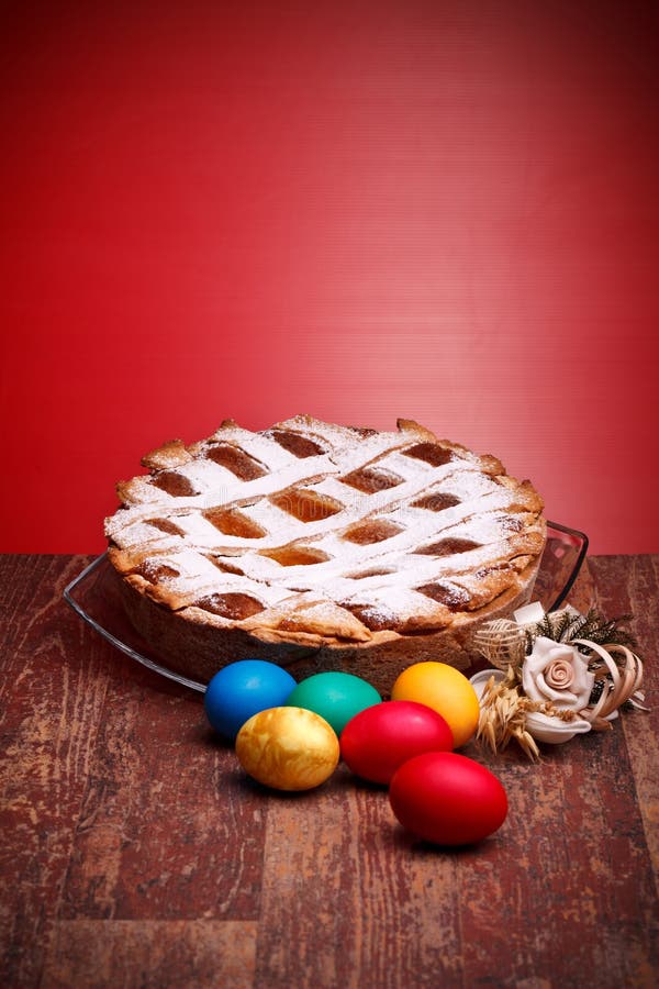 International Cuisine - Desserts - Neapolitan Pastiera and colorful Easter eggs. Pastiera is a wheat and ricotta pie that is also known as Pizza Gran. International Cuisine - Desserts - Neapolitan Pastiera and colorful Easter eggs. Pastiera is a wheat and ricotta pie that is also known as Pizza Gran.