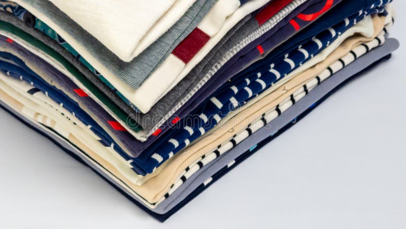 Stack of Folded Colorful Clothes on a White Background stock photo