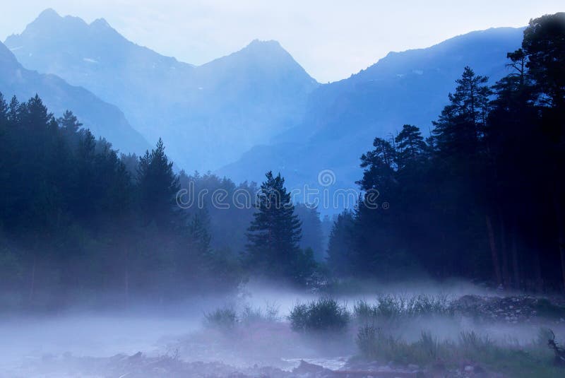 Fog over the river. Forest and high mountains. Fog over the river. Forest and high mountains