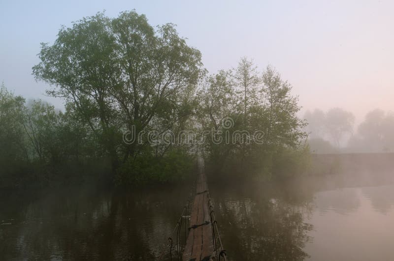Nebeliger Morgen D?mmerung au?erhalb der Stadt Die Br?cke ?ber dem Fluss stockfotografie Nebeliger Morgen D?mmerung au?erhalb der Stadt Die Br?cke ?ber dem Fluss stockfotografie
