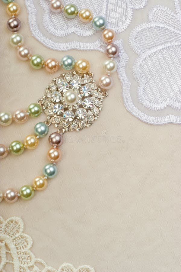 Necklace with brooch on lace background