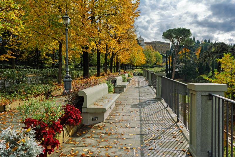 Fall in Florence â€“ view to Basilica San Miniato al Monte from sunlit Belvedere Vittorio Sermonti, cloudy day, Tuscany, Italy. Fall in Florence â€“ view to Basilica San Miniato al Monte from sunlit Belvedere Vittorio Sermonti, cloudy day, Tuscany, Italy