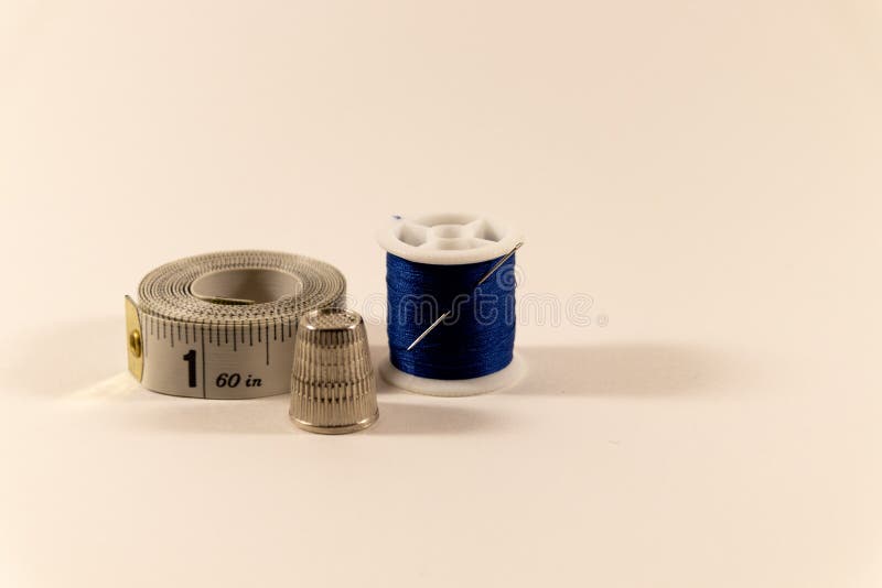 Needle And Thread, Thimble, And Measuring Tape Stock Image Image of