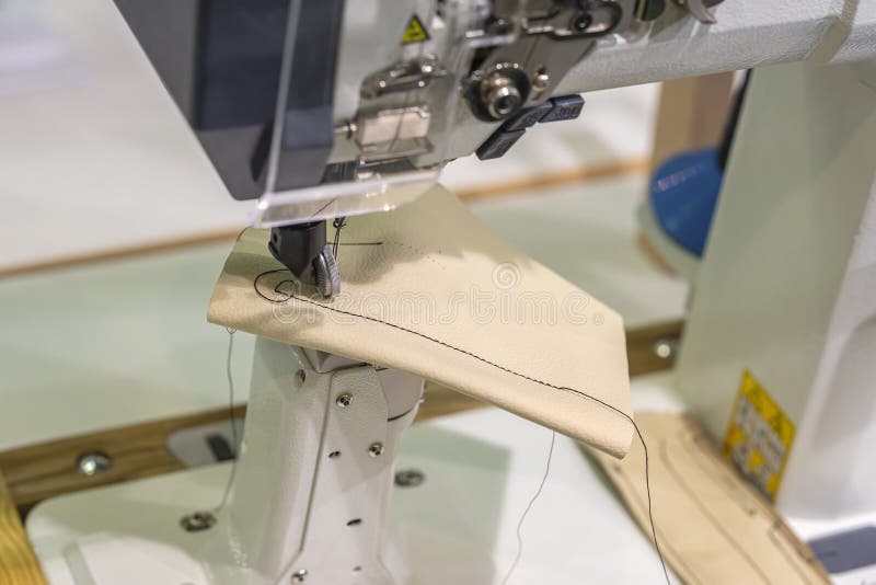 Needle of Industrial Sewing Machine and Piece of Leather with Thread