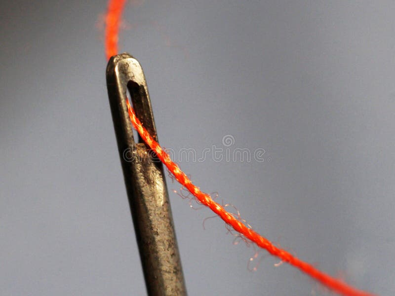 sewing needle with thread, Macro of the needle eye of a sew…
