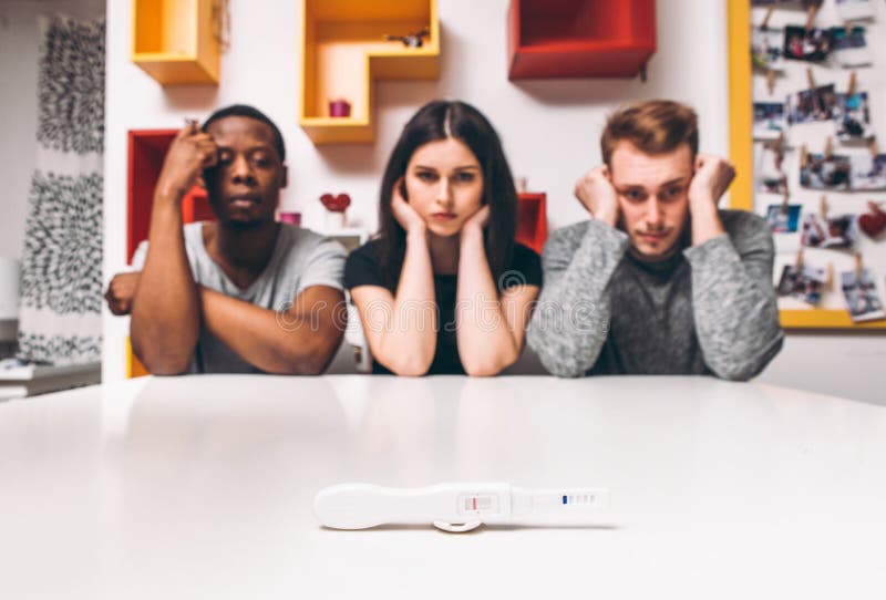 Negative pregnancy test result, woman with two man