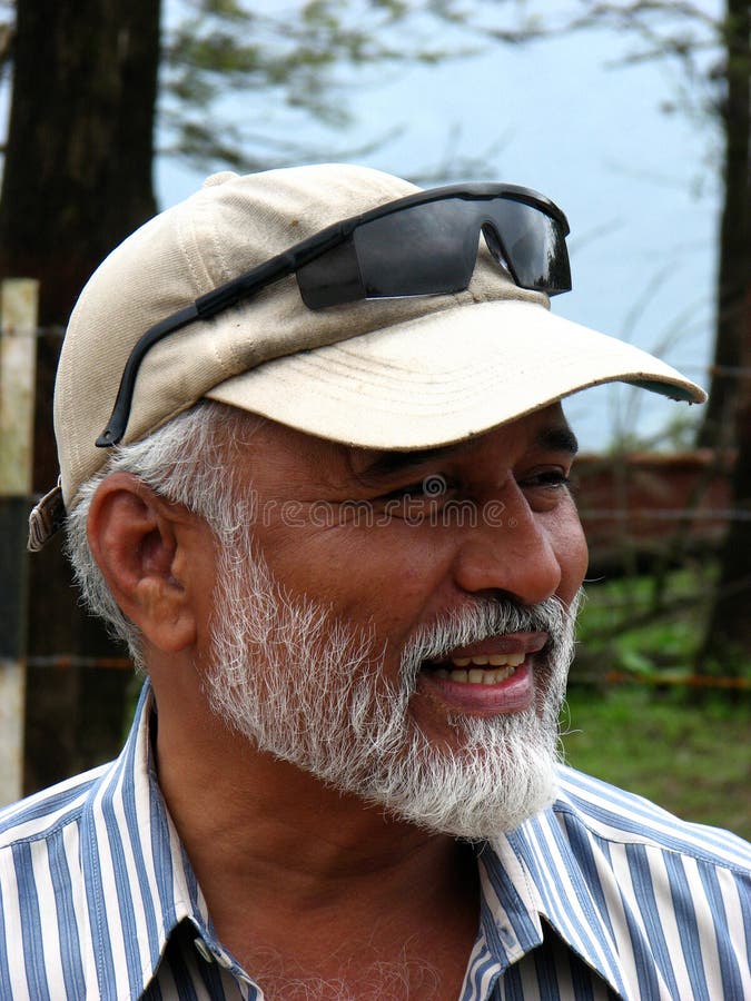 A handsome looking Indian senior talking with someone. A handsome looking Indian senior talking with someone