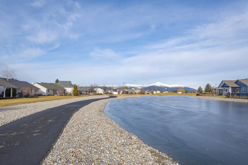 A neighborhood subdivision of homes in a golf course community adjacent to a fairway and water feature pond in Post Falls, Idaho royalty free stock photo A neighborhood subdivision of homes in a golf course community adjacent to a fairway and water feature pond in Post Falls, Idaho royalty free stock photo