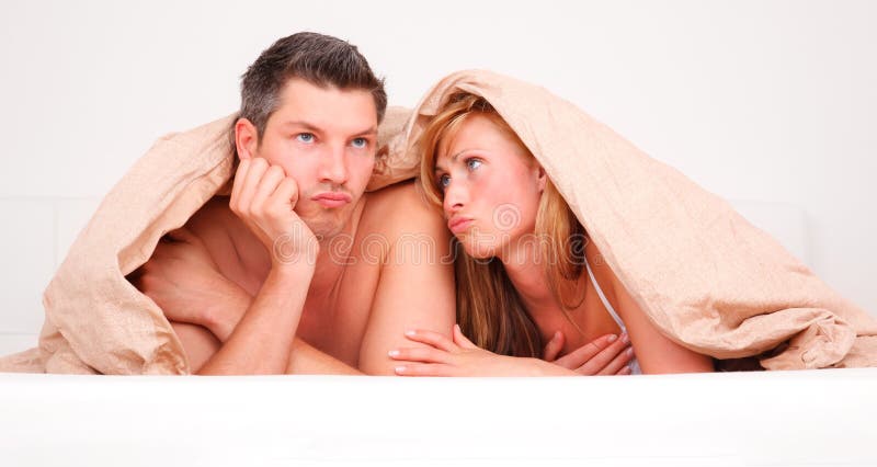 Upset frustrated and bored couple lying in bed having no sex. Upset frustrated and bored couple lying in bed having no sex