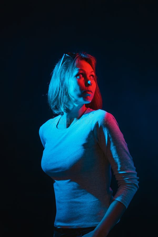 The Neon Lights of the Club. Portrait of a Young Woman Posing in Half  Turn.Side Blue and Red Light. Black Background. Vertical Stock Image -  Image of colourful, light: 163639627