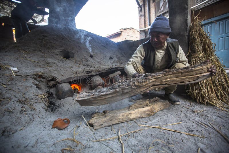 Nepalese man working in the his pottery workshop. stock photos