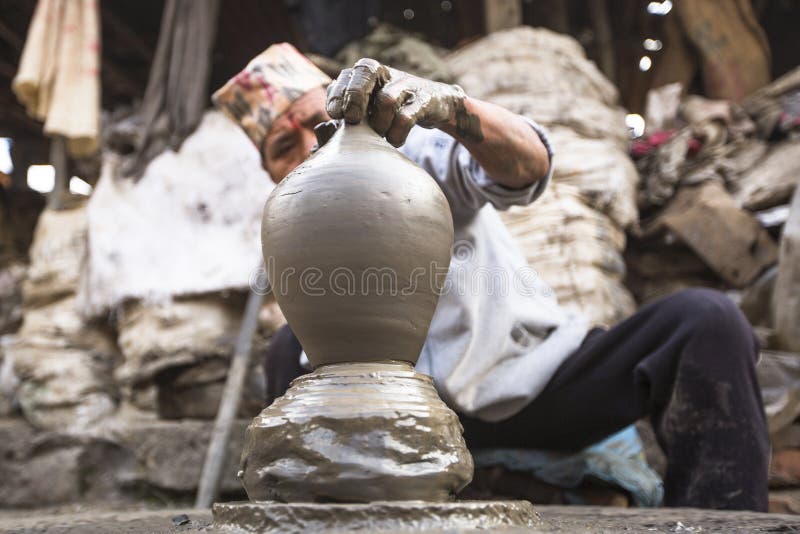 Nepalese man working in the his pottery workshop. stock images