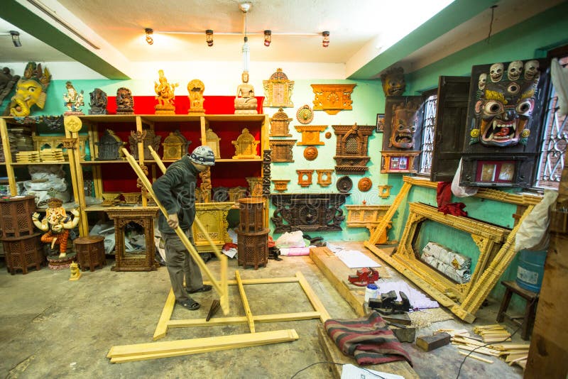 Nepalese man working in his wooden workshop. stock photo