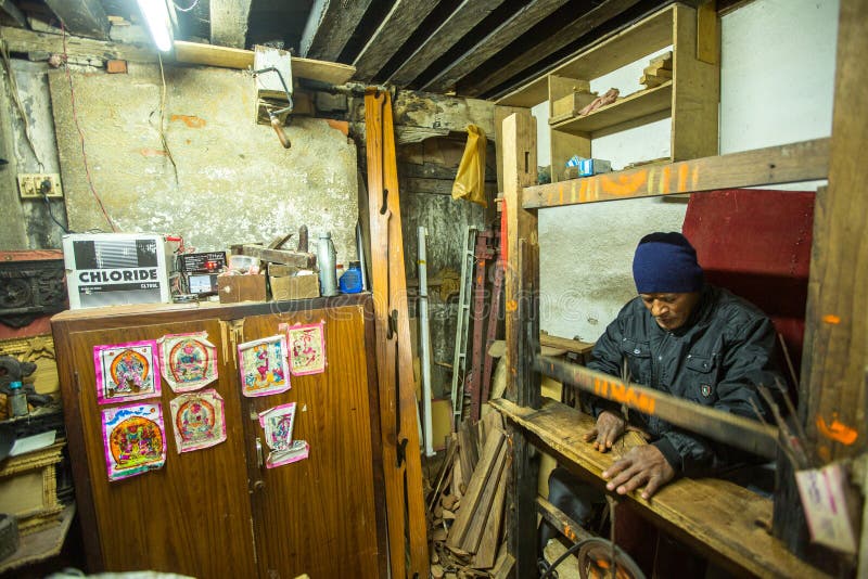 Nepalese man working in his wooden workshop. More 100 cultural groups have created an image of Bhaktapur as Capital of Nepal royalty free stock image