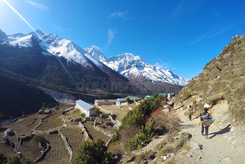 Nepalese porter (sherpa), small mountain village stock images Nepalese porter (sherpa), small mountain village stock images