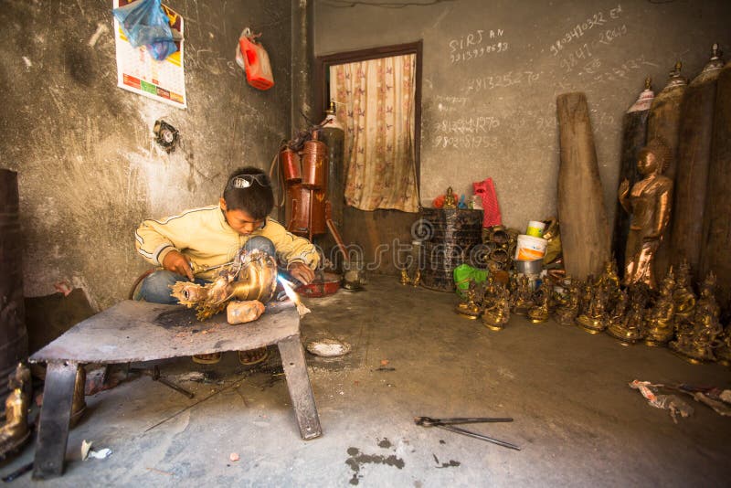 Nepalese tinman working in the his workshop, in Bhaktapur, Nepal. stock photos