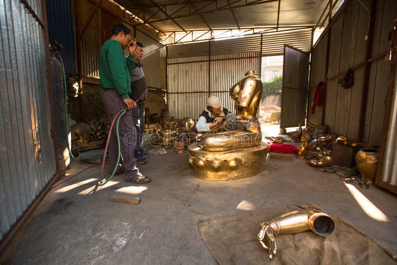 Nepalese tinman working in the his workshop, in Bhaktapur, Nepal. royalty free stock image