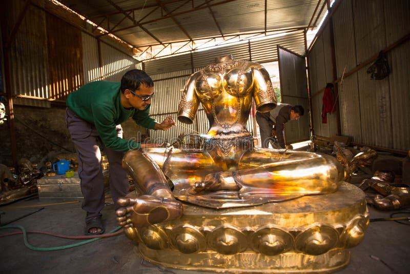 Nepalese tinman working in the his workshop, in Bhaktapur, Nepal. stock photo