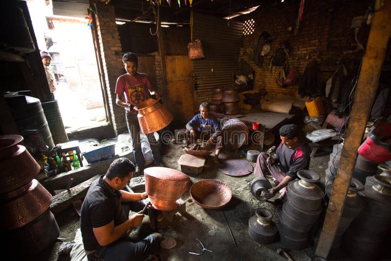Nepalese tinmans working in the his workshop. More 100 cultural groups have created an image Bhaktapur as Capital of Nepal Arts. stock image