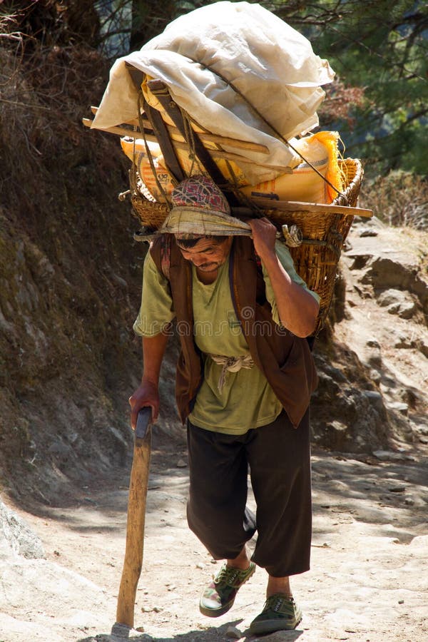 Nepali porter carrying 80 kgs of rice from Lukla airport to Namche Bazaar. Nepali porter carrying 80 kgs of rice from Lukla airport to Namche Bazaar