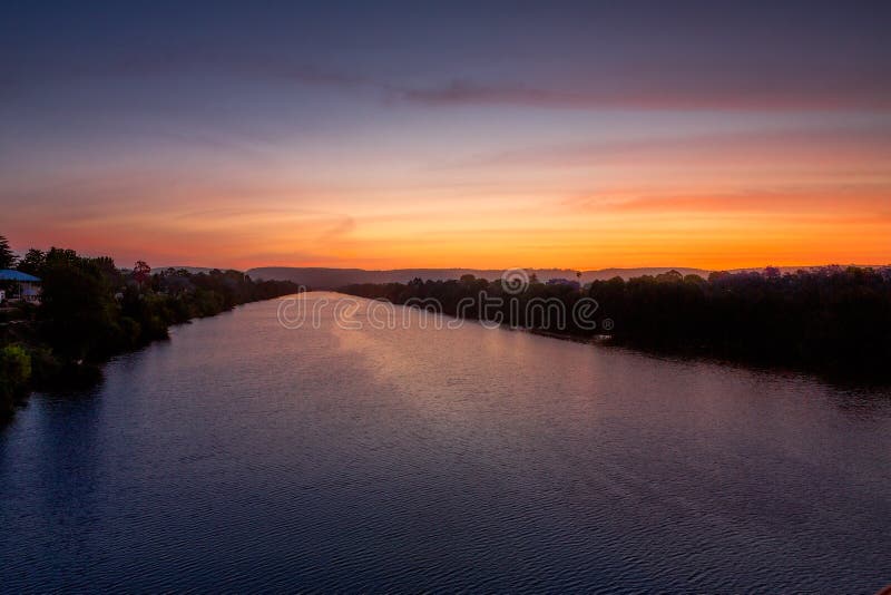 Nepean River glowing with reds and blues at sunset