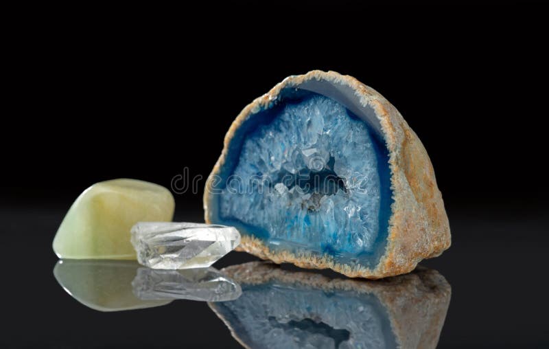 Nephrite, clear quartz crystal, blue agate geode with quartz crystals royalty free stock photos