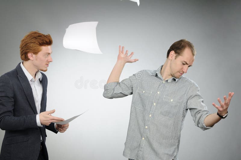Nervous man throwing papers stock image