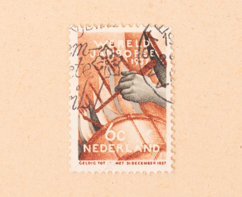 A stamp printed in the Netherlands shows someone playing the drums, circa 1950 stock photos