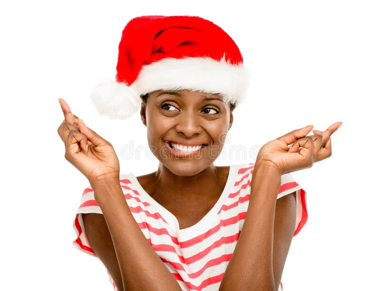 Nette Afroamerikanermädchenfinger kreuzten tragenden Weihnachtshut lizenzfreie stockbilder Nette Afroamerikanermädchenfinger kreuzten tragenden Weihnachtshut lizenzfreie stockbilder