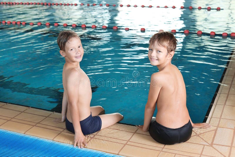 Nette kleine Jungen nahe Hallenbad stockbilder